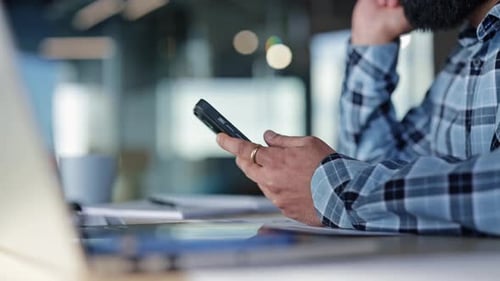 Businessman Using Mobile Phone at Desk in Office Sending Text Message