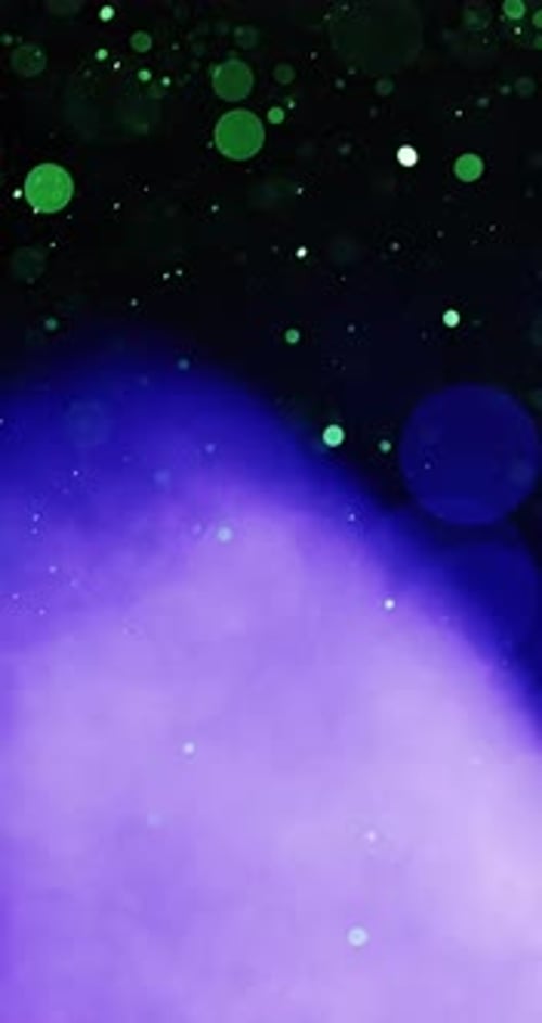 Green And Blue Particles Swirling Upwards