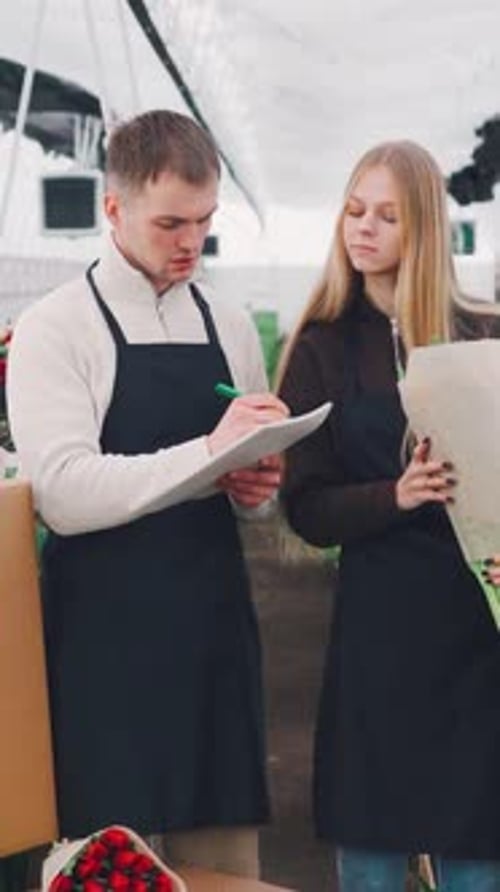 Young Adults Working in Flower Greenhouse