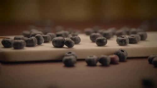 Pile of fresh blueberries on wooden surface