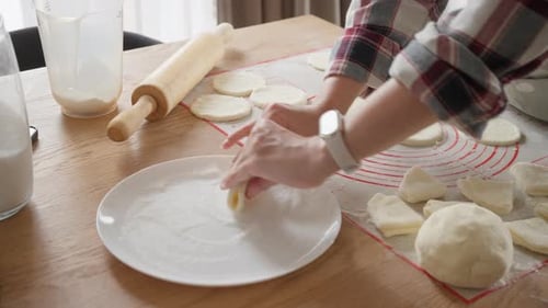 Woman Prepares Dough for Delicious Homemade Dumplings
