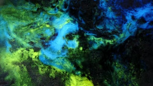 view of glowing blue and green liquids swirling in an abstract, dreamlike motion