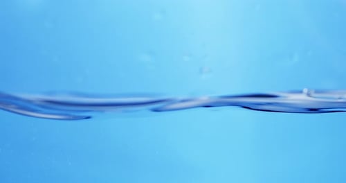 Fluid Motion in Nature: View of Blue Water Waves Creating Smooth Ripples