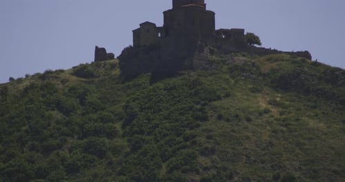 Dense Vegetation Reveal Jvari Monastery On Mountain Peak Near Mtskheta, Eastern Georgia. Tilt-up, Re