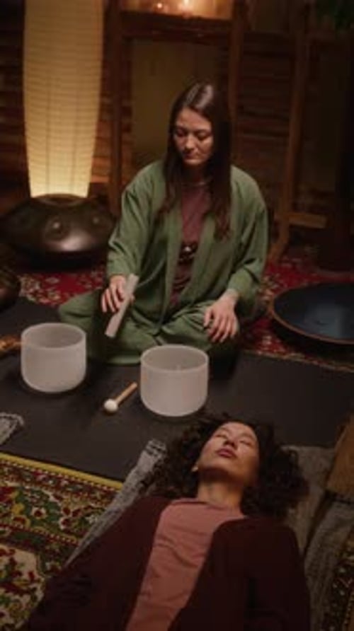 Female Guru Performing Sound Healing Ritual with Singing Bowls