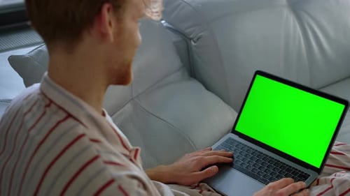 Guy Using Green Laptop Computer Closeup. Online Teacher Talking Video Conference At