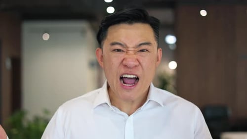 Angry Man Expresses Frustration in Office Setting