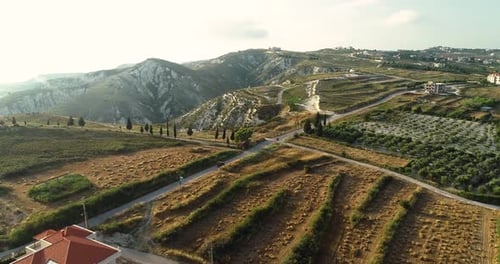 Picturesque scenic flight above wheat farm being harvested in beautiful rural countryside field towa