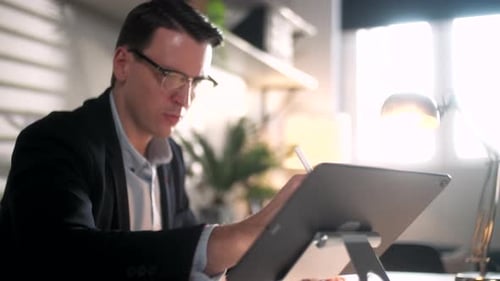 Architect Working In Office Draws With Pen Or Tools On Tablet Business Portrait Of Handsome Business