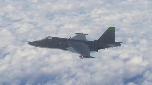 Military Jet Flying Above Clouds