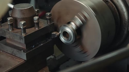 Close up shot of a steel workpiece rotates on a lathe the process of processing a steel workpiece on