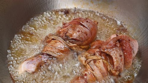 Chicken Drumsticks Frying in Pan Close Up