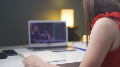 Woman examining and thinking financial chart.