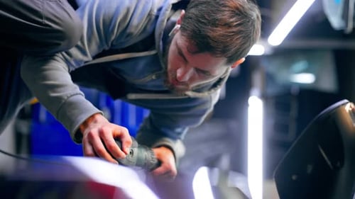 Vertical Video the Car Mechanic at a Service Station Doing the Final Polishing to Shine