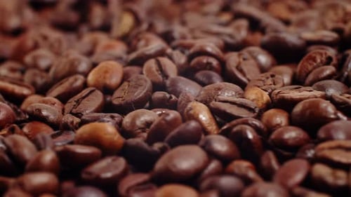 Close Up of Roasted Brown Coffee Beans Rotating Background Roasted Coffee Beans