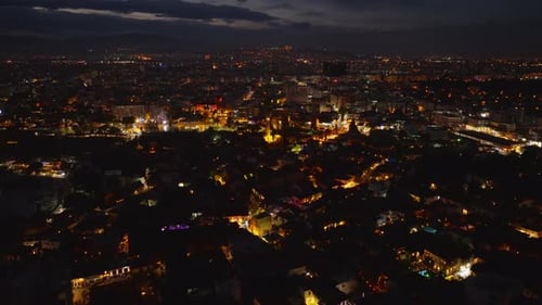 Aerial Panoramic View of City at Night Colour Streetlights Glowing and Illuminating Surrounding