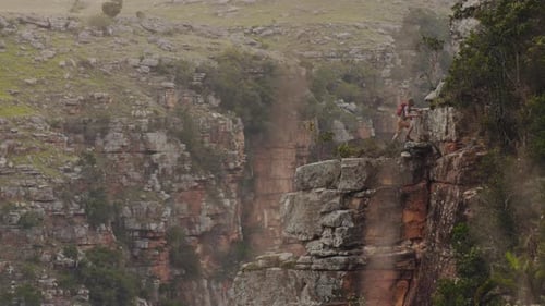Of Young Free Climber and Hiker, Climbing Mountain Cliff at Sunset,