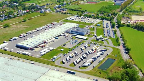 Aerial view of goods warehouse. Logistics center in industrial city zone from above. Aerial view of