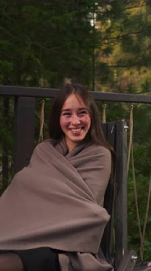 Woman Smiles to Boyfriend on Hotel Terrace