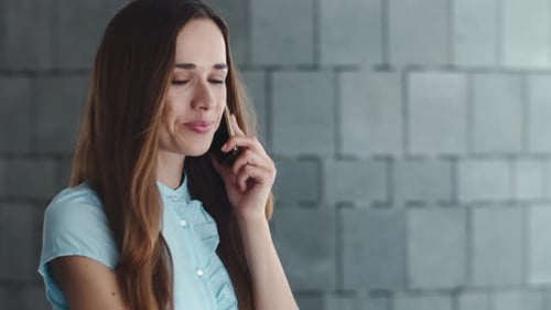 Woman Smiles While Talking on Mobile Phone