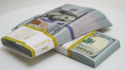 Stack of Bank Bundles with US Dollars on a White Background Closeup Shot of New Freshly Printed