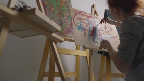 Woman Painting at Easel in Art Studio