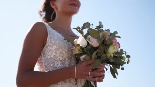 Bride Holding Bouquet on a Sunny Day