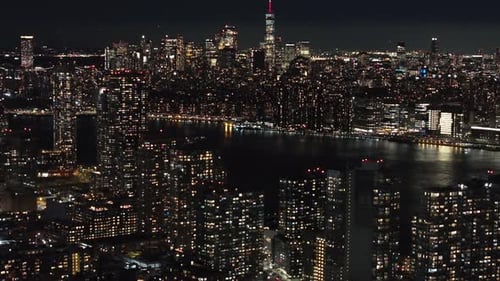 Aerial View of Lower Manhattan and the East River at Night Camera Moves Above New York Skyscrapers