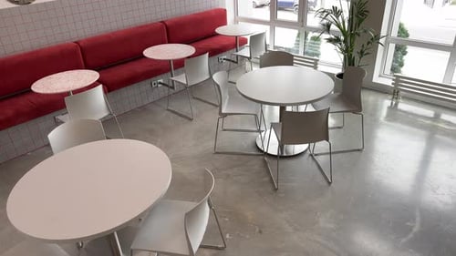 Minimalist Cafe Interior with White Furniture and Red Seats