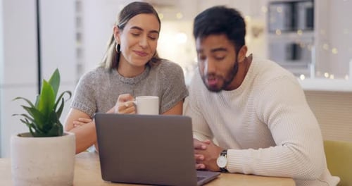 Couple Using Laptop Computer Together at Home