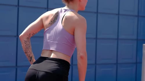 Athletic Woman Exercising with Resistance Band Outdoors