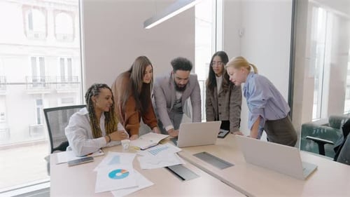 A Group of Diverse Professionals Engaged in Collaboration Within a Modern Office Environment