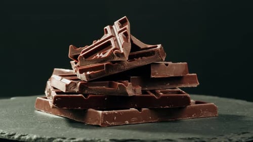 Stack of Chocolate Bar Pieces on Gray Stone