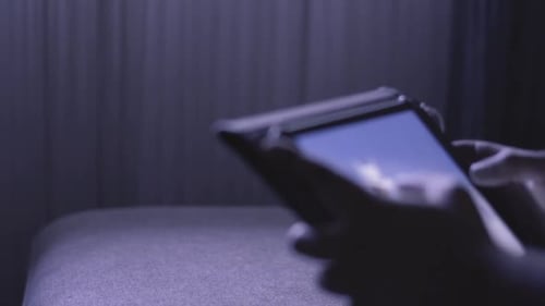 In Zeitlupe gedreht und zeigt die Hände eines Mannes beim Surfen in sozialen Medien oder beim Spielen mit einem mobilen Tablet bei