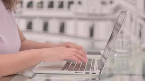 Close Up of African Woman Typing on Laptop