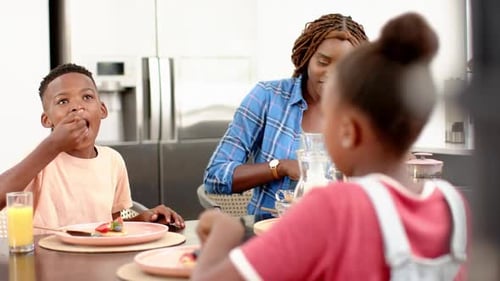 Mother and Children Enjoying Meal at Home