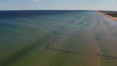Beautiful flight in summer over the beach. People are resting near the sea.