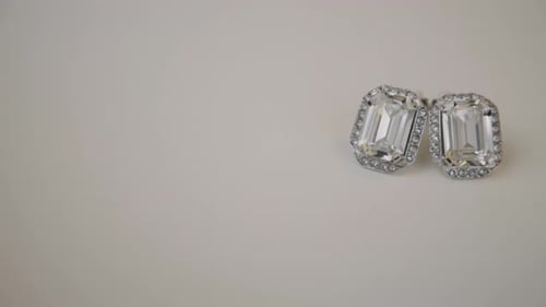 A Pair Of Emerald Cut Moissanite Halo Stud Silver Earrings With Diamond. slider left shot