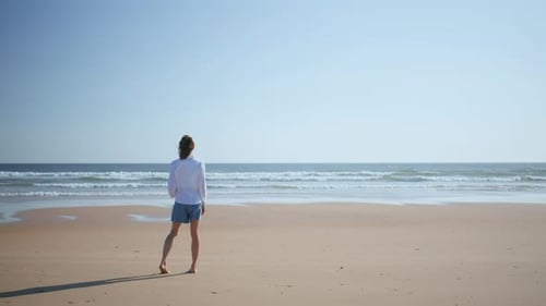 Woman Strolling Serene Beach in Summer Sunlight Lady Enjoying Rest Near Ocean