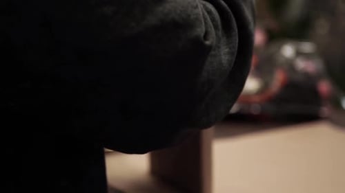 Hands Wrapping Brown Package at Workplace