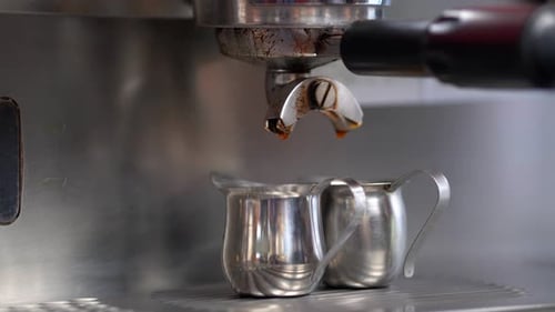 Cafeteria making an espresso or American coffee preparation from a coffee machine