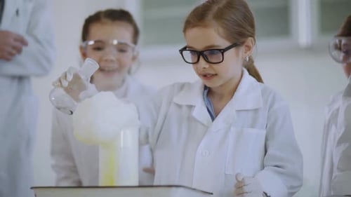 Excited Children Doing Science Experiment in a School Lab