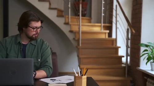 Man Working at Laptop in Home Office