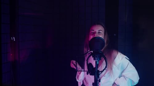 Woman Singer Enjoying Singing and Dancing in Music Studio