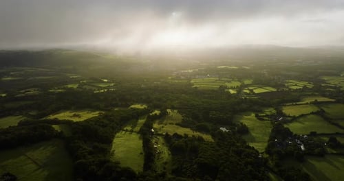 The Sun Emerges From Behind The Clouds Over Stunning English Countryside Aerial View