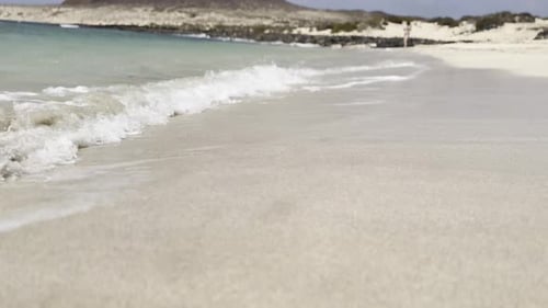 Waves Crashing on Sandy Beach