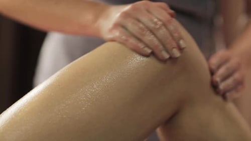 Woman's Leg Receives Massage Treatment With Oil
