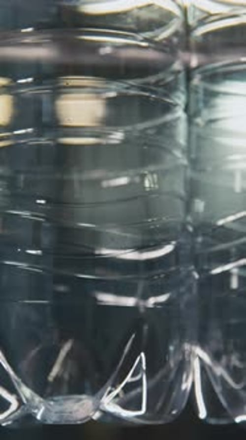 Vertical of Empty PET Bottles Moving on Robotic Automation Line