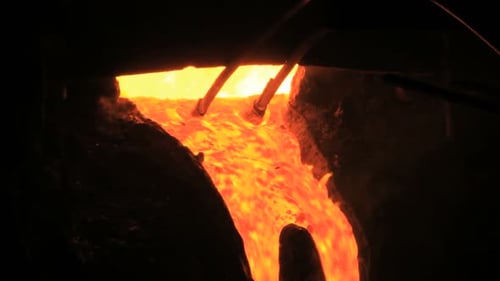Molten Metal River Pouring in Dark Industrial Setting