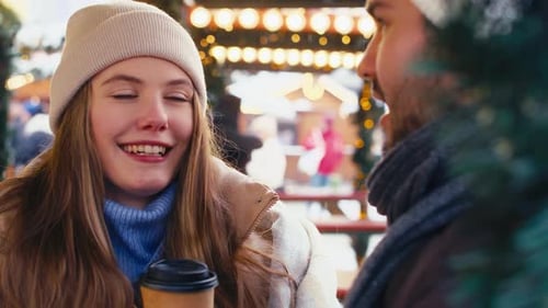 Caucasian couple having fun on Christmas market